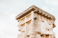 Close-up view of ancient stone ruins showcasing weathered architecture under a clear sky.